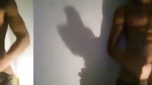 Dark-Hued man films himself while milking off