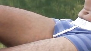 Jerking boy attracts a sunbathing youngster