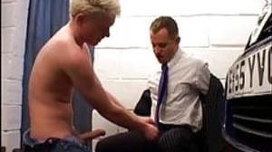 Young car mechanic servicing older gay businessman