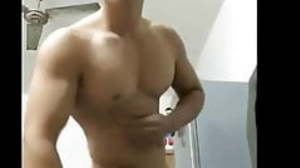 Asian dude flexes muscles and shows his naked body