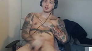 Full tattoos mendicant jerks off his cock until he